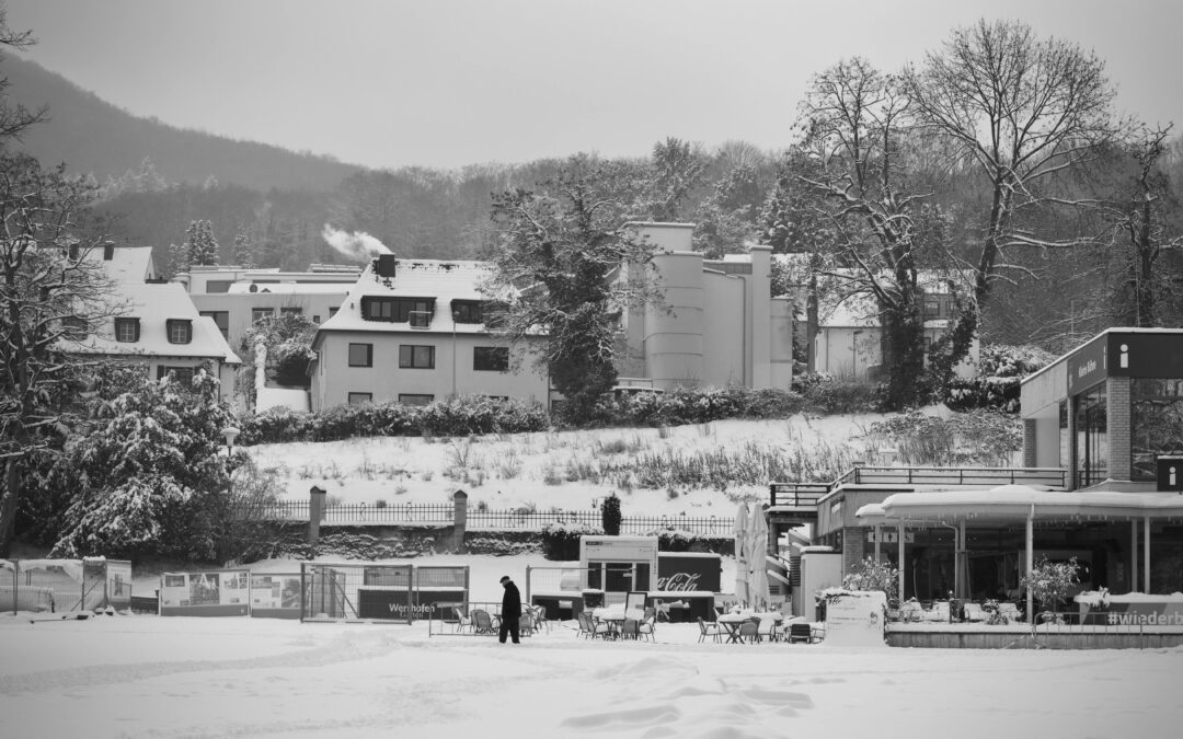 Black and white urban sketching reference photo of a small town covered in snow.